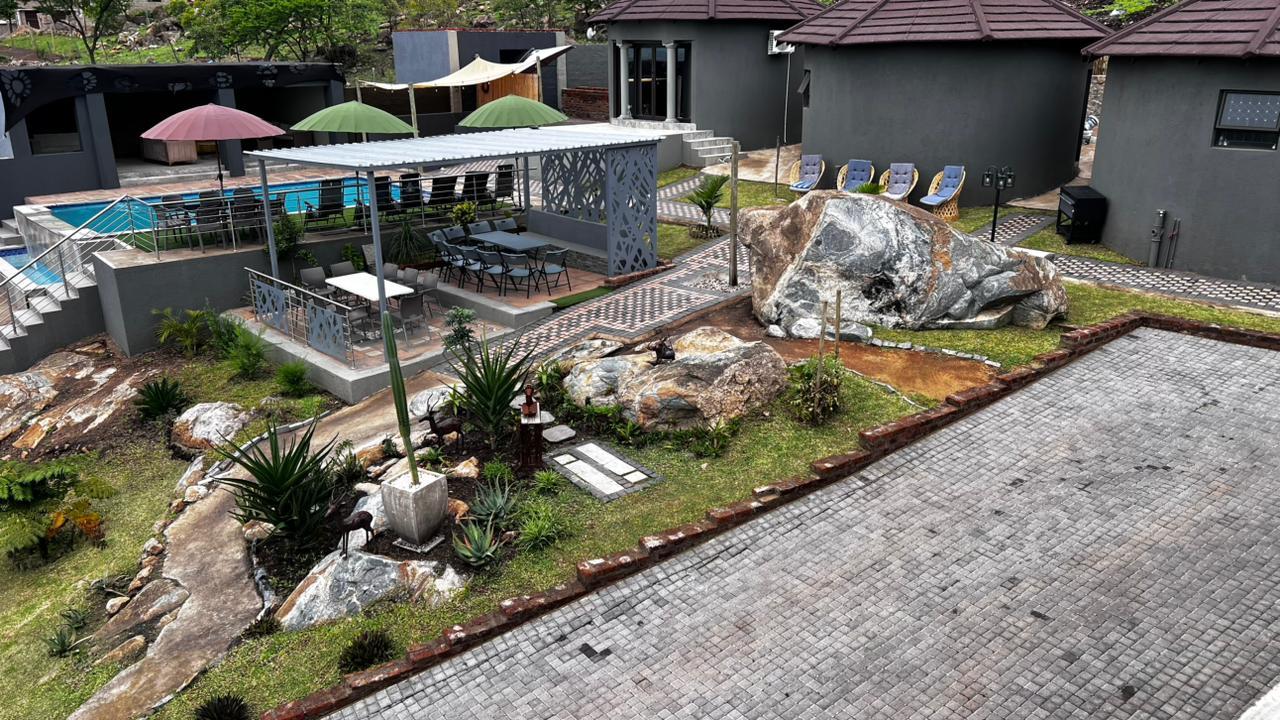 Aerial view of the lodge gardens, pool, pergola dining area and rock features